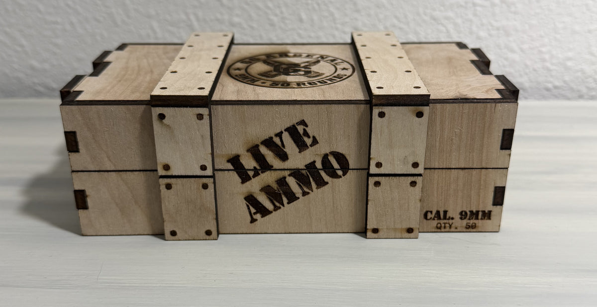 Front of empty wooden crate engraved LIVE AMMO and CAL. 9MM / QTY. 50.