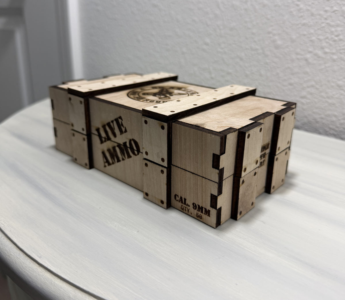 Closed handmade wooden storage crate with removable lid and engraved GG Arsenal emblem, sold empty.