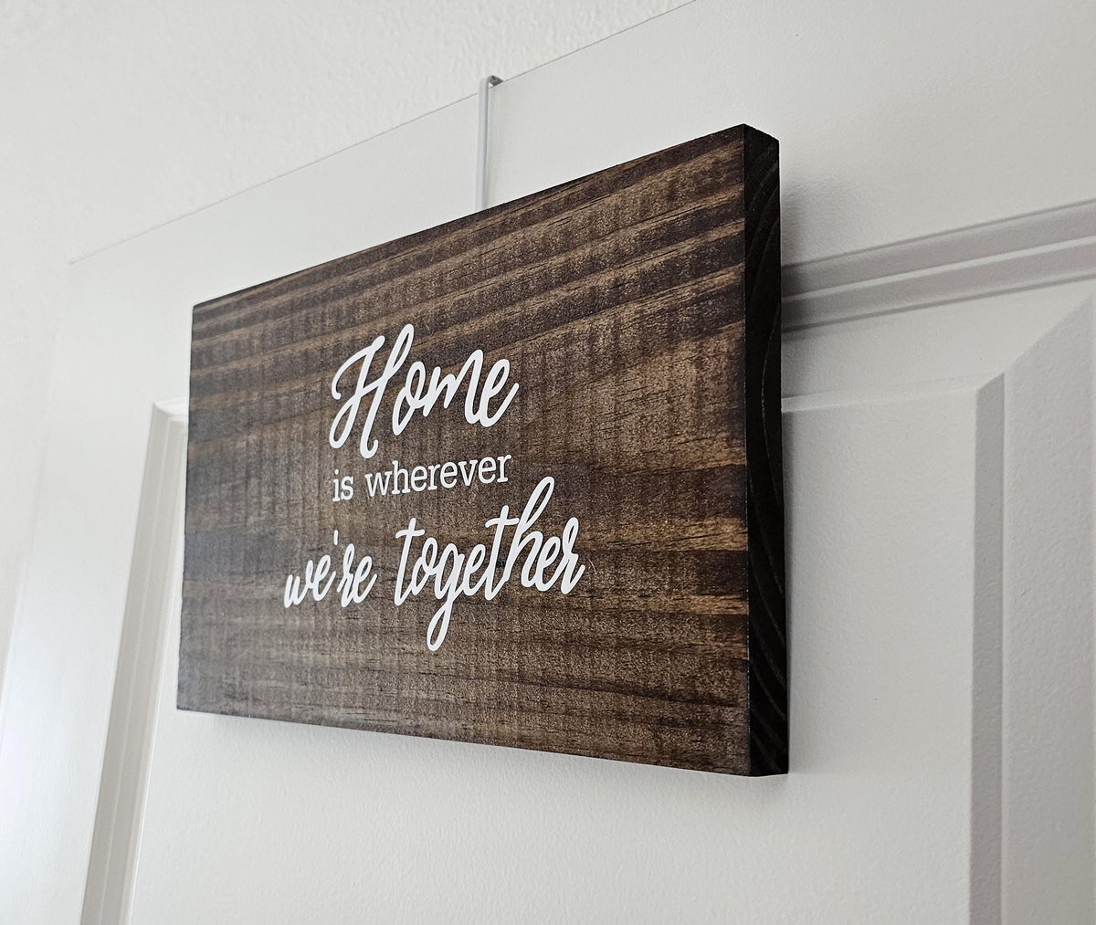 Stained pine quote sign displayed on a door