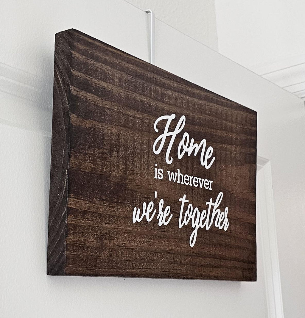 Hanging wooden sign with white vinyl lettering