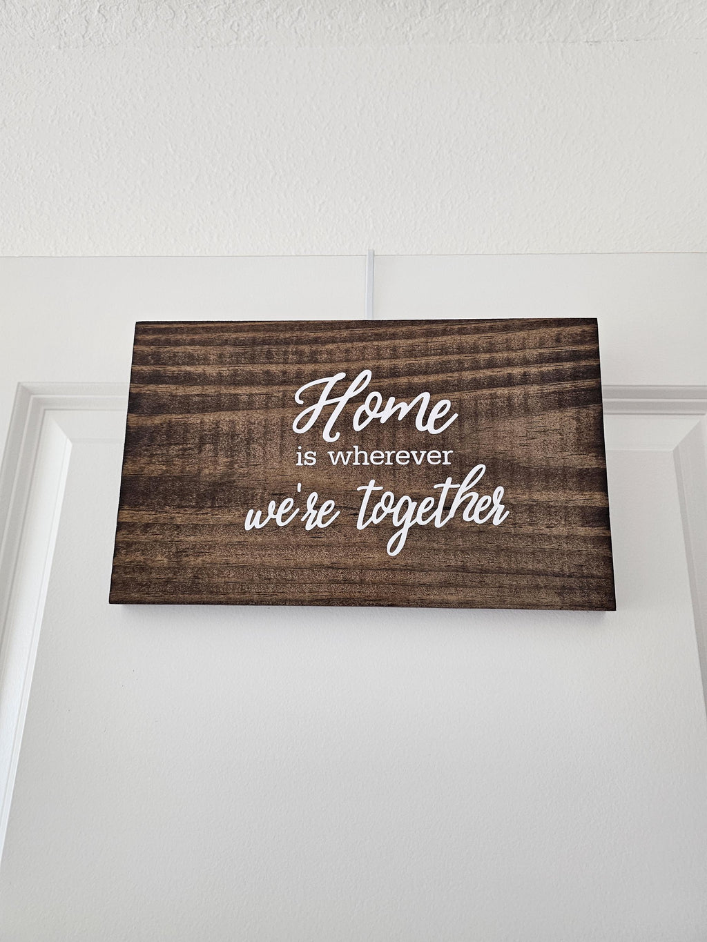 Close-up of the wood grain and Home is wherever we're together lettering