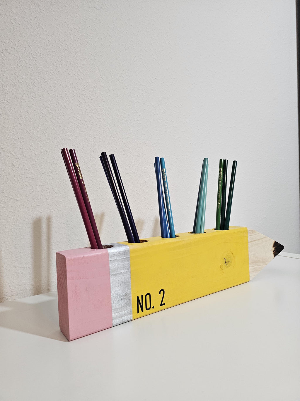 Wooden No. 2 pencil organizer holding colored pencils