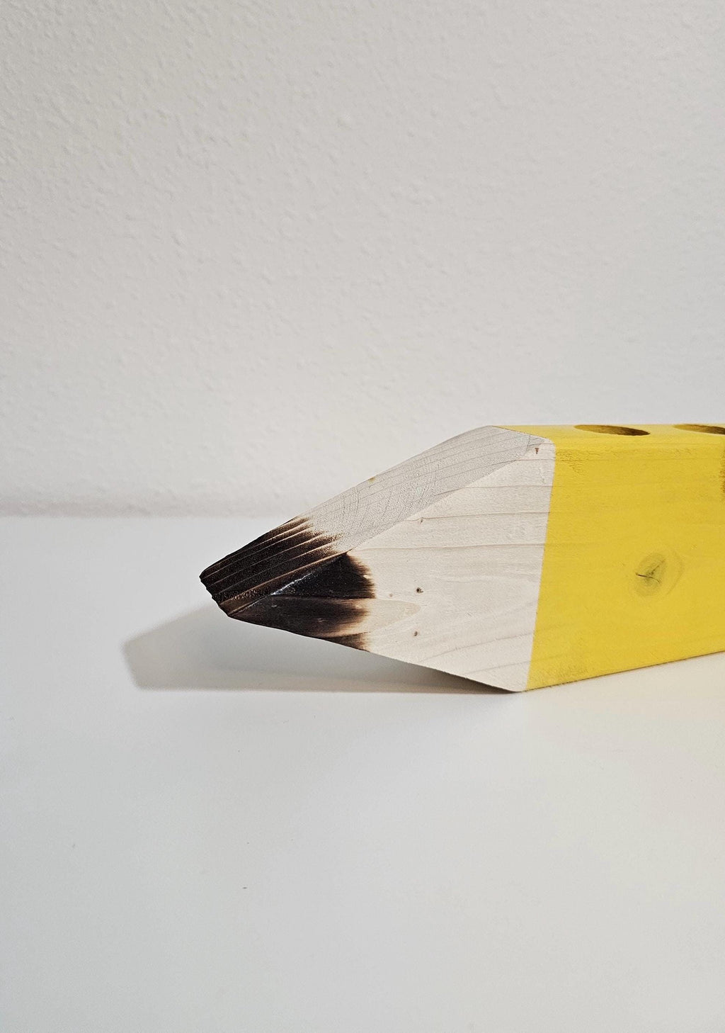 Torch-burned wood pencil tip detail